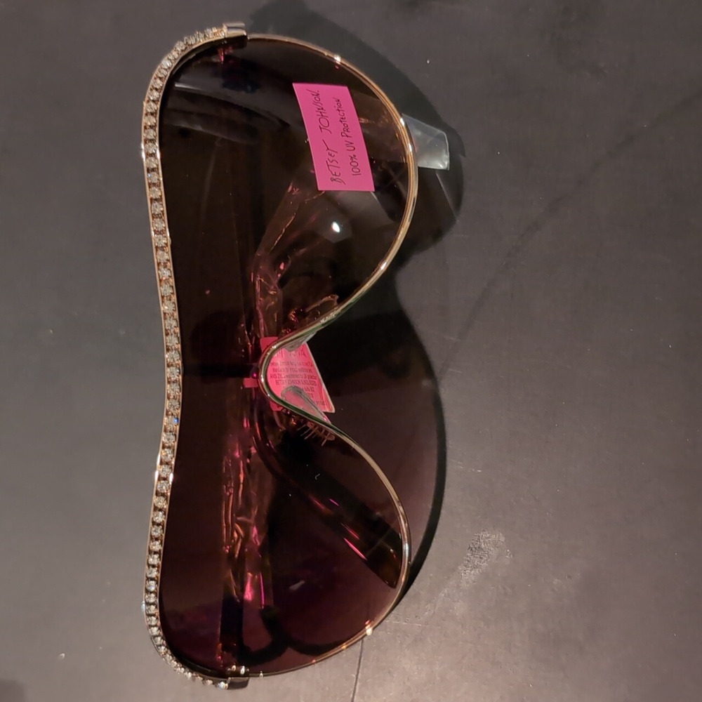 Gold studded shield sunglasses by Betsey Johnson